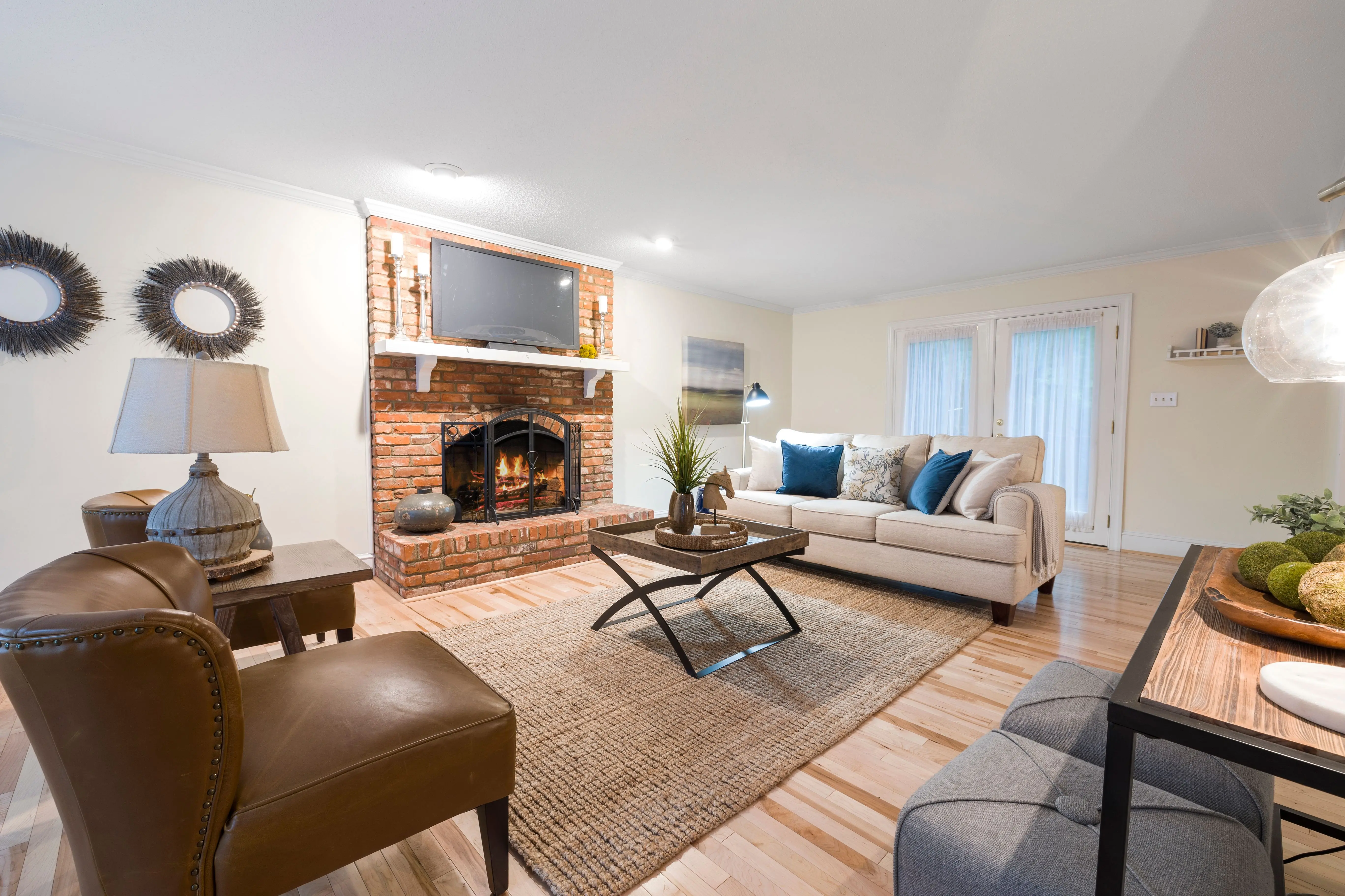 diy outdoor fireplace Inviting living room featuring cozy seating, brick fireplace, and stylish decor.