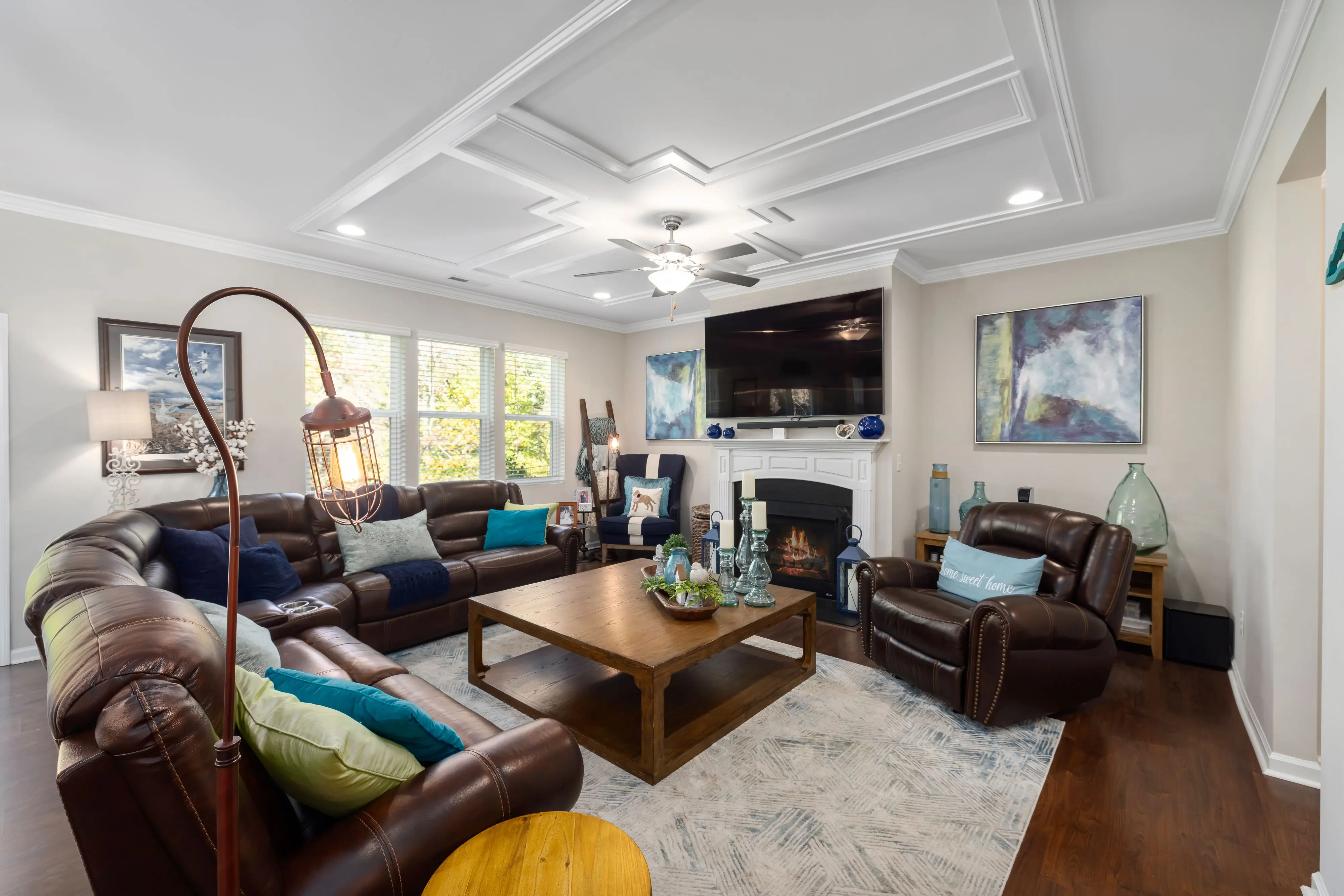 brown sectional sofa Stylish and welcoming living room with modern decor, leather sofas, and elegant furnishings.