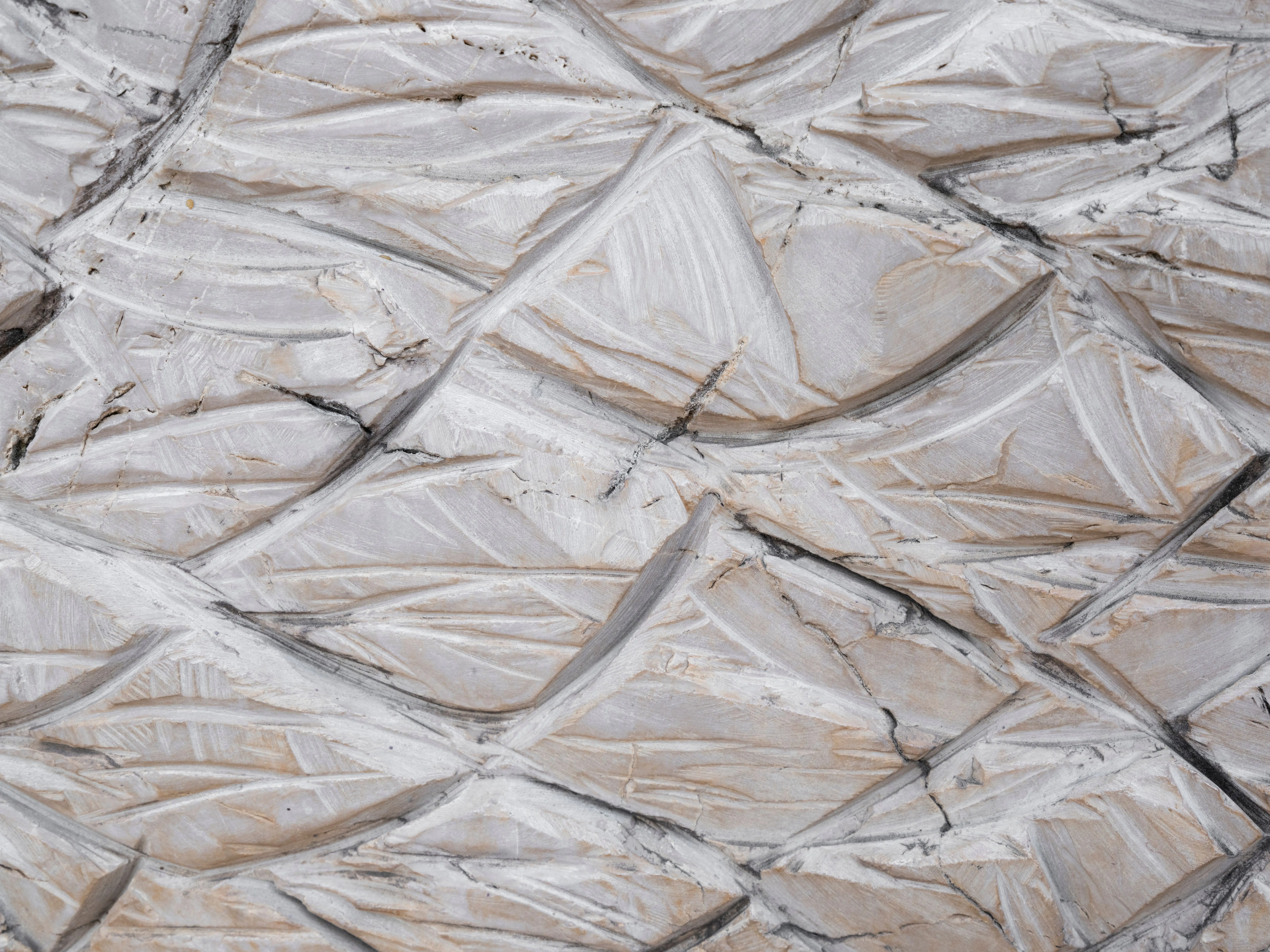 cinnamon slate color Close-up of an intricately textured stone surface with geometric patterns creating an abstract design.