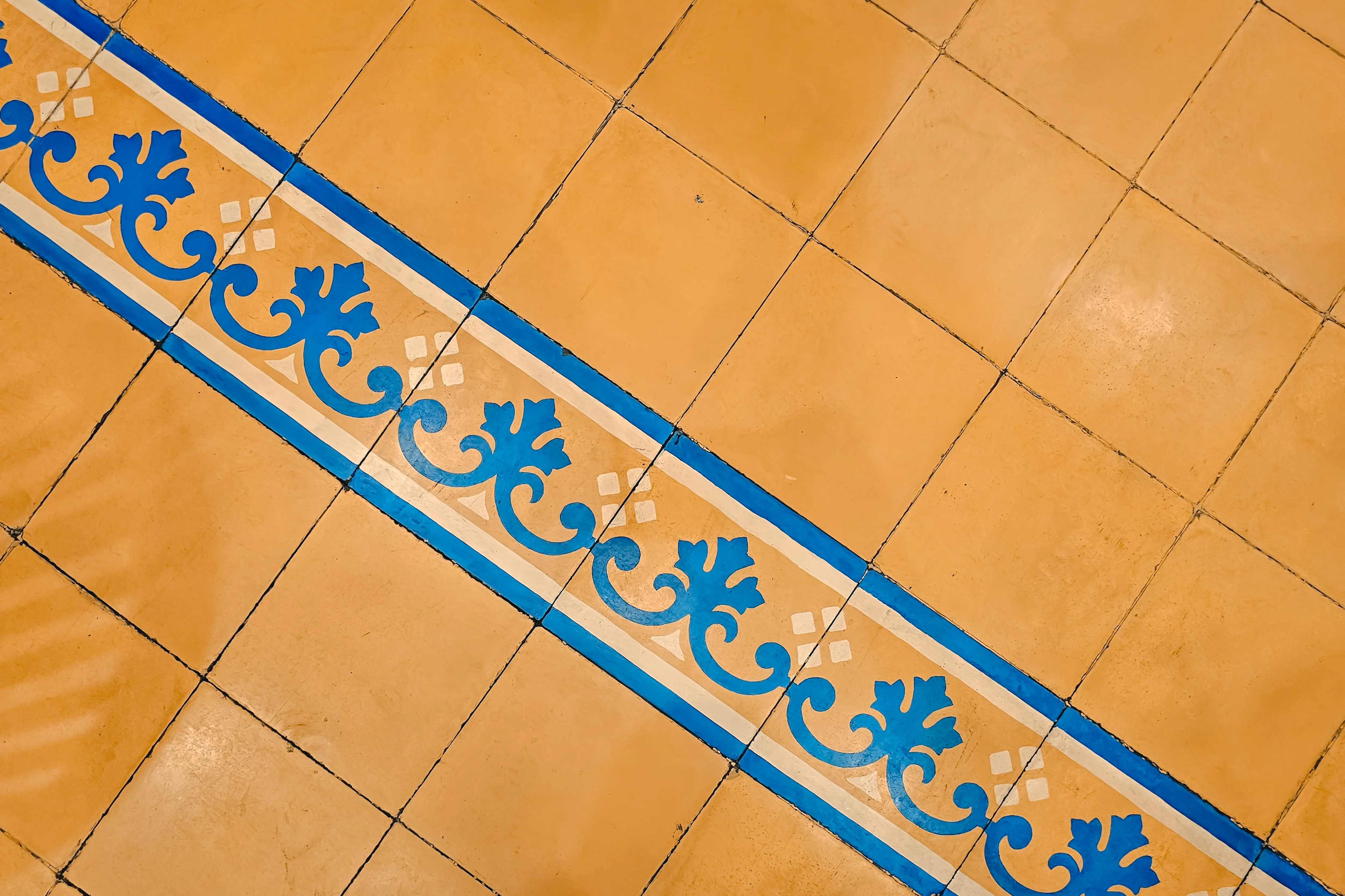 blue floor tile Central Java tile design with blue ornate pattern on yellow background, ideal for decor inspiration.