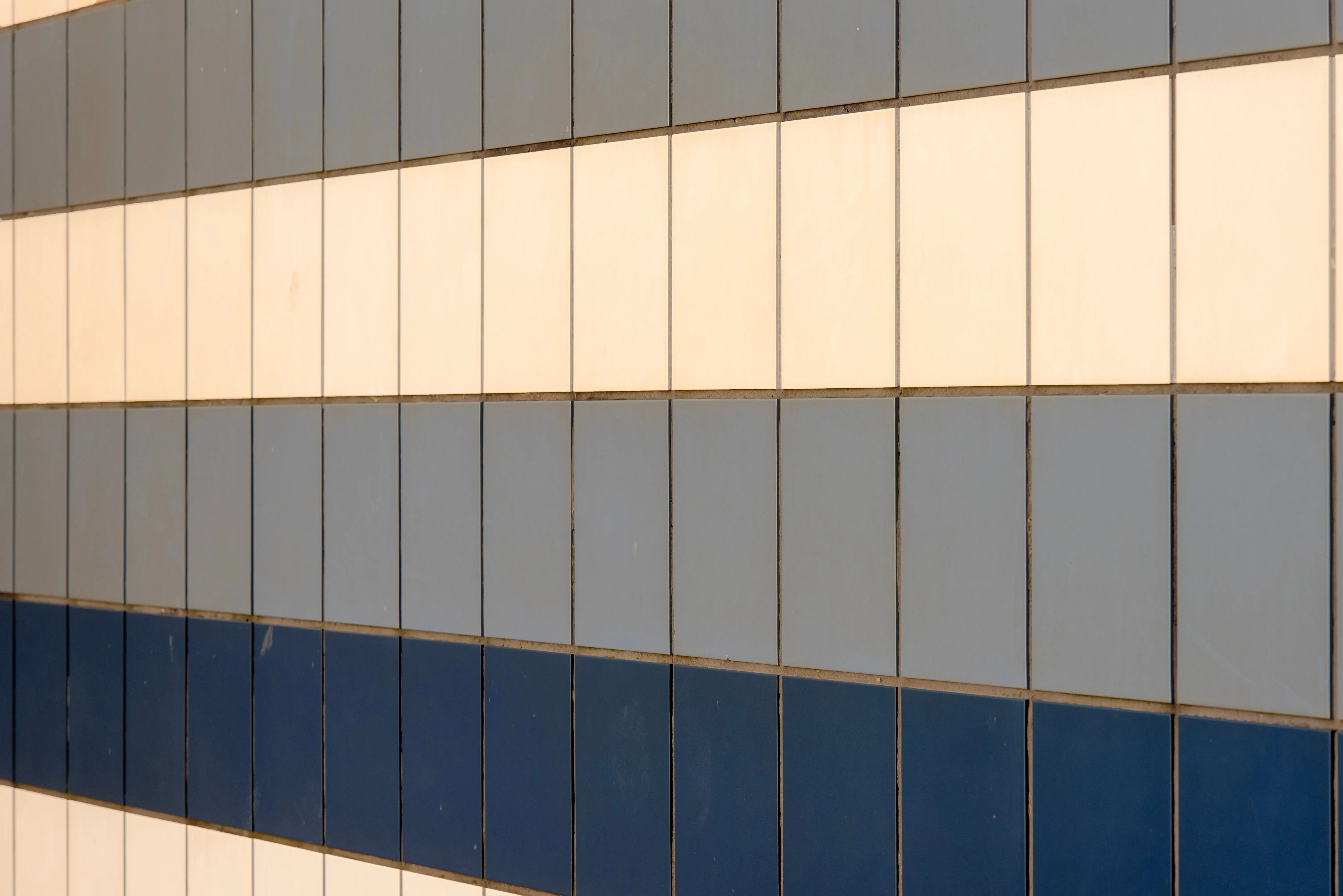 blue subway tile A geometric wall pattern of blue and white tiles creating a harmonious visual effect.