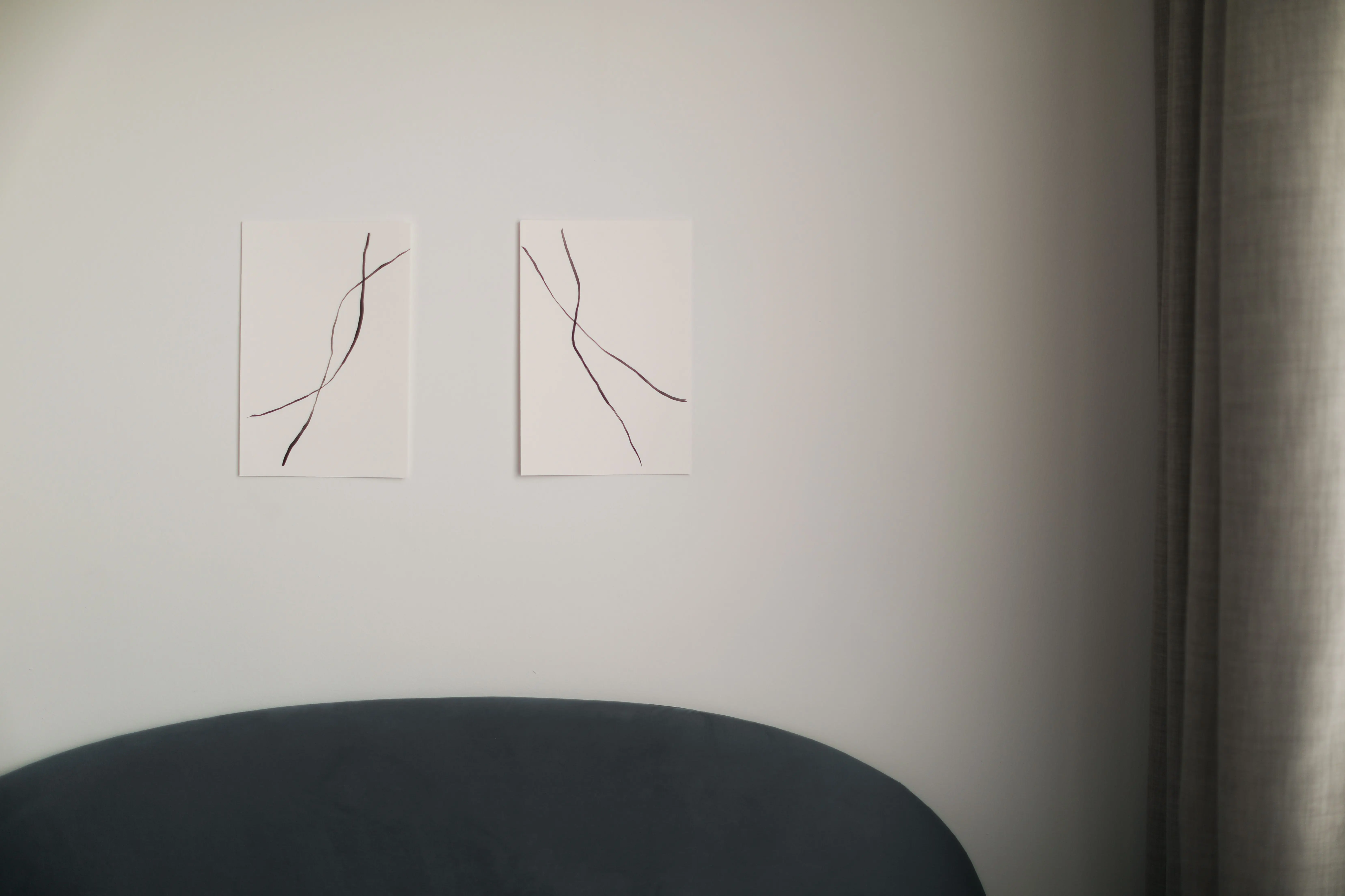 abstract prints Abstract linear wall art in a minimalist modern living room with soft lighting.