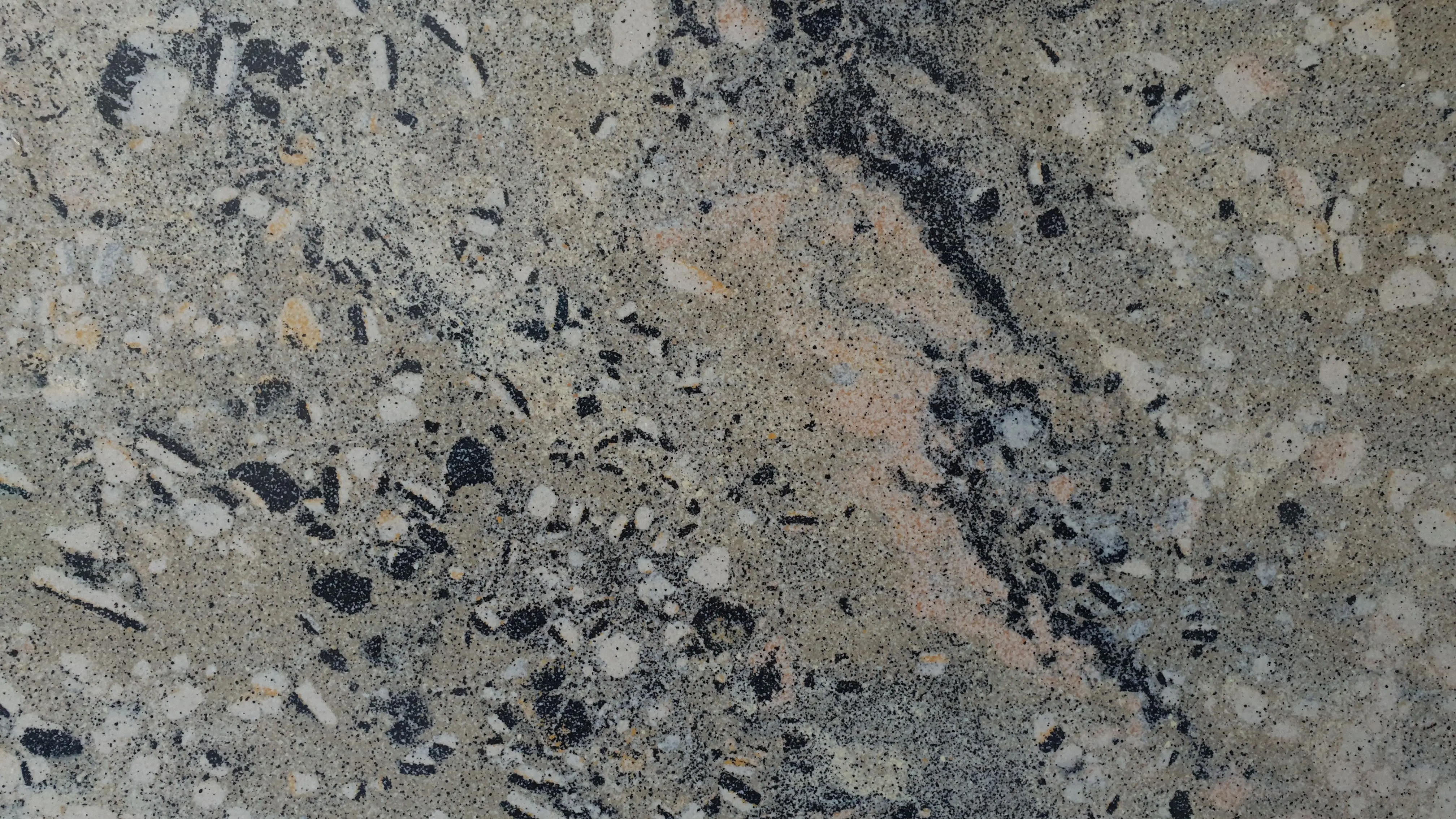 gray granite countertops Close-up of a textured granite surface with a natural pattern.