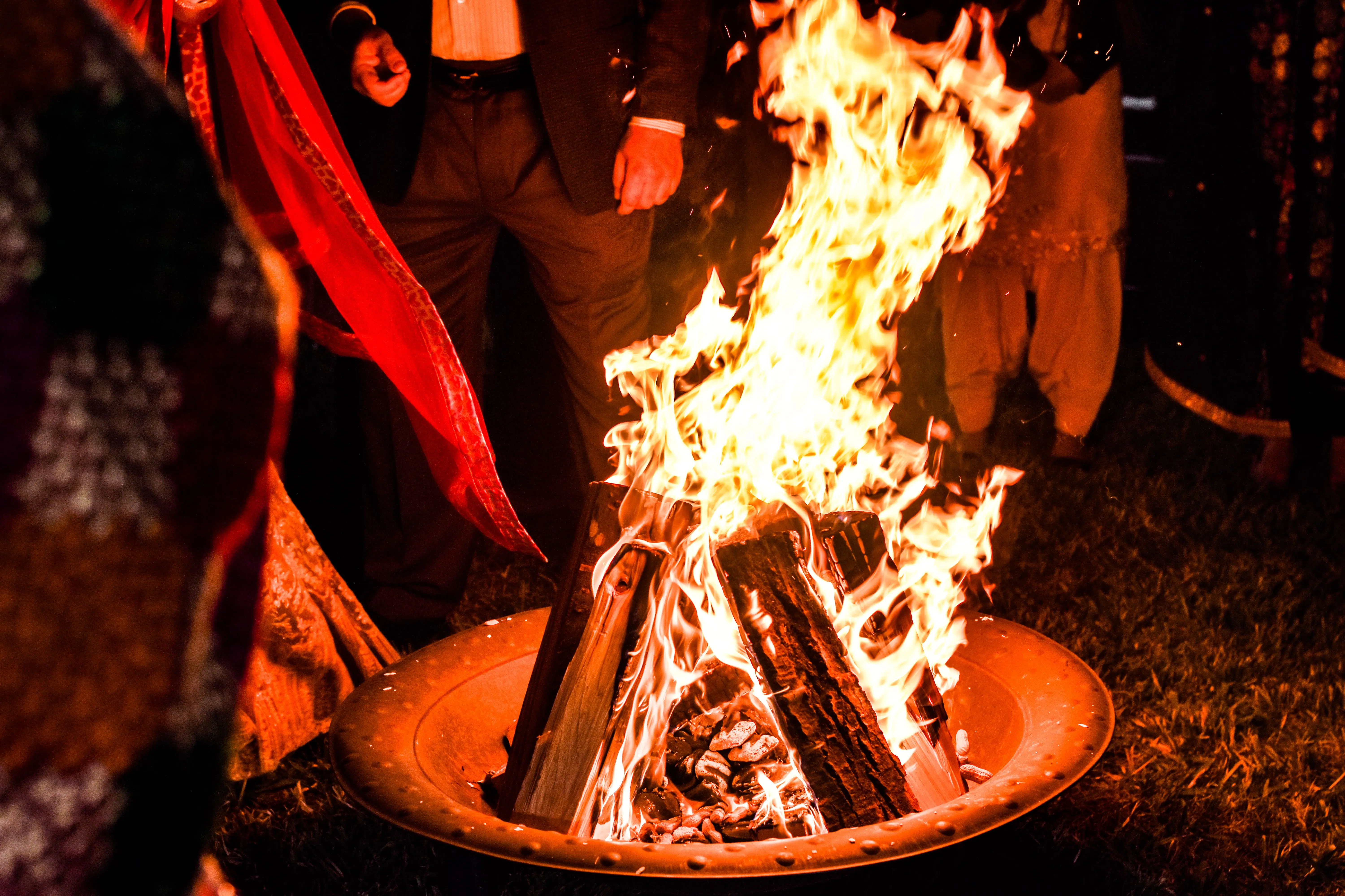 diy outdoor fireplace A group of people gather around a warm bonfire at night, creating a cozy atmosphere.