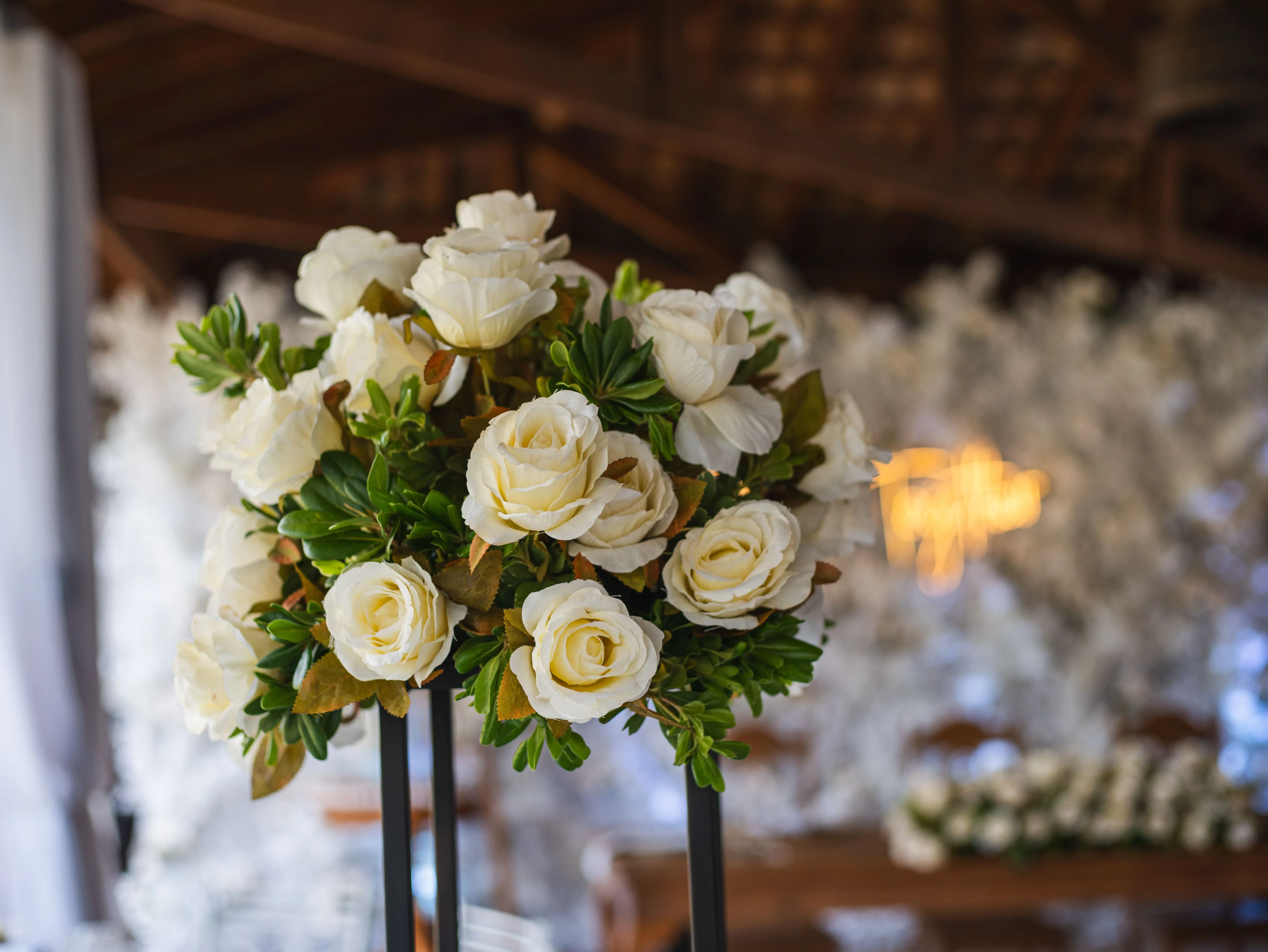 big bouquet of roses A beautiful floral arrangement of white roses in a rustic wedding setting in Brazil.