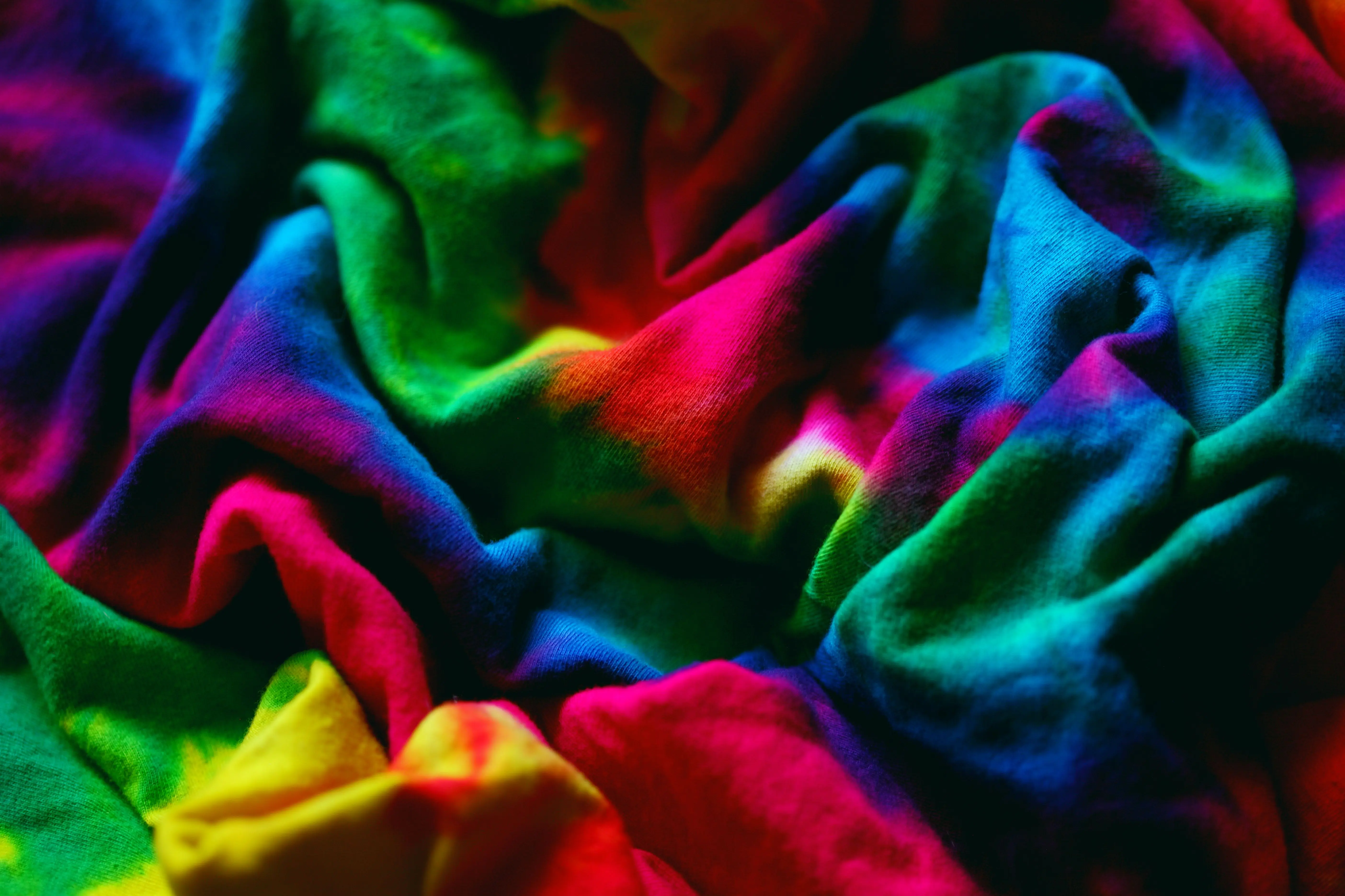 cool tie dye patterns Colorful close-up of crumpled tie-dye fabric showcasing vibrant hues and dynamic patterns.
