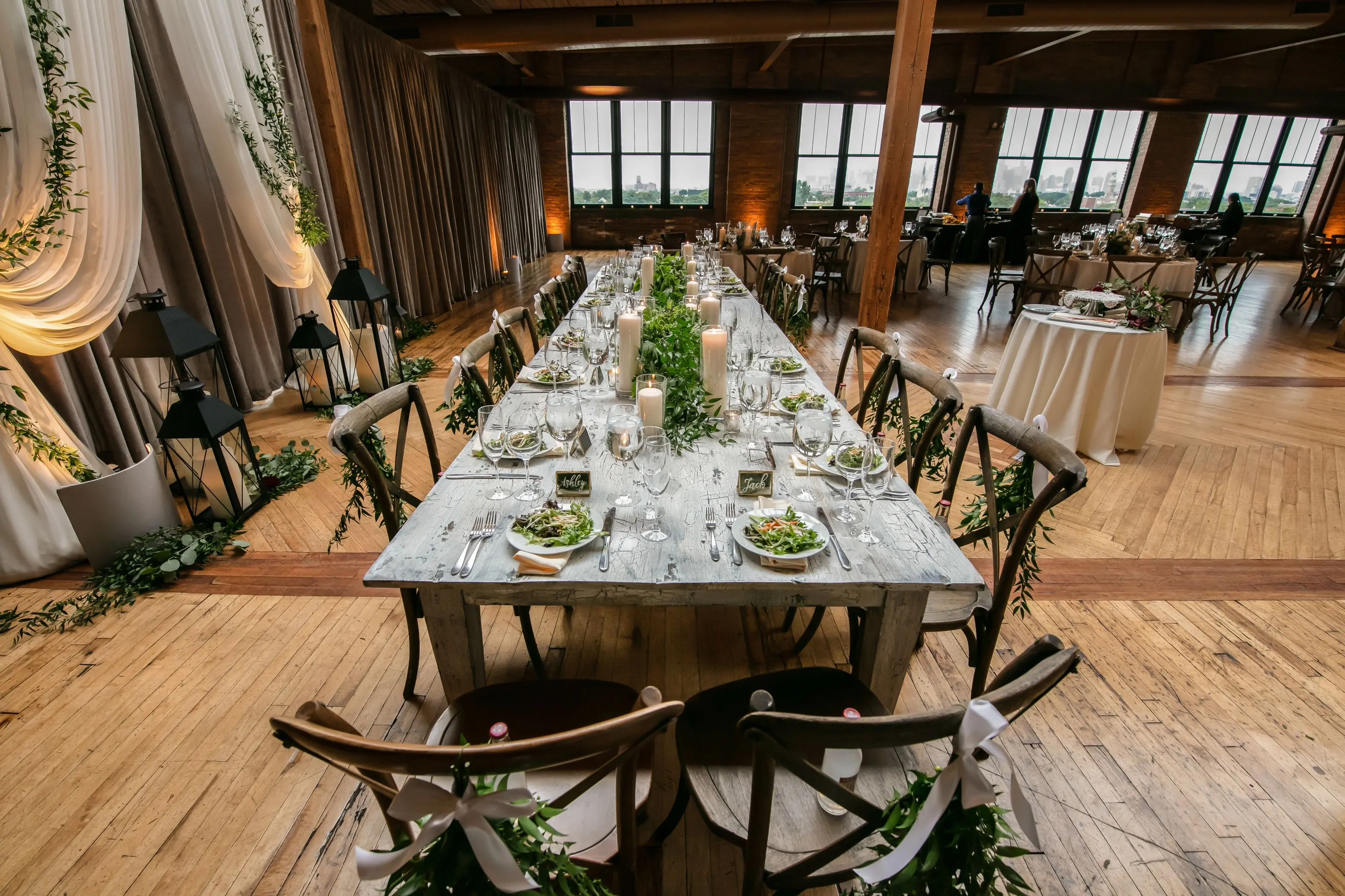 extension dining table Stylish wedding reception table setup in a Chicago loft with candles and greenery.